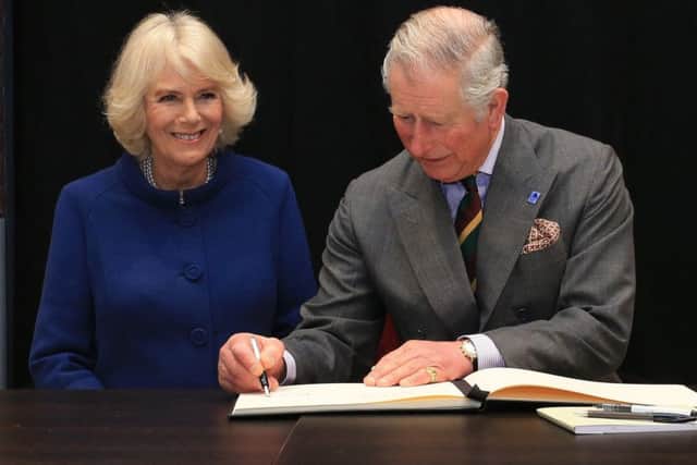 The Prince of Wales and the Duchess of Cornwall signing the visitors book after touringthe Ferens Art Gallery in Hull on Wednesday