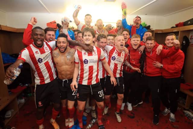 Lincoln City players celebrate their victory.