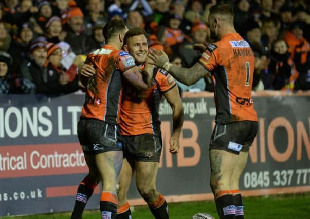 Luke Gale celebrates his second try and the Tigers' sixth with Greg Eden and Zak Hardaker.   Picture Bruce Rollinson