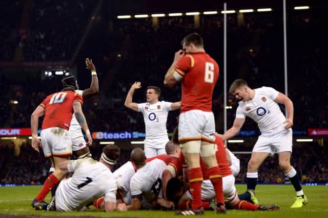 England's Ben Youngs scores his side's first try as George Ford (centre) and Owen Farrell (right) celebrate.