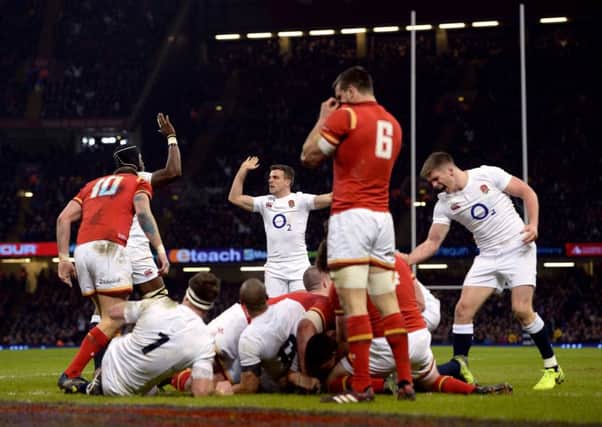 England's Ben Youngs scores his side's first try as George Ford (centre) and Owen Farrell (right) celebrate.