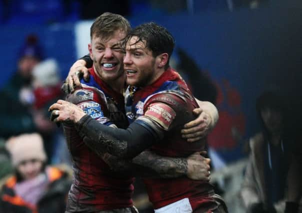 Wakefield's Scott Grix celebrates his opening try with Tom Johnstone.