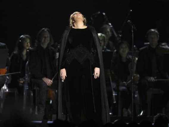 Adele apologizes before restarting a performance tribute to George Michael at the 59th annual Grammy Awards on Sunday in Los Angeles.