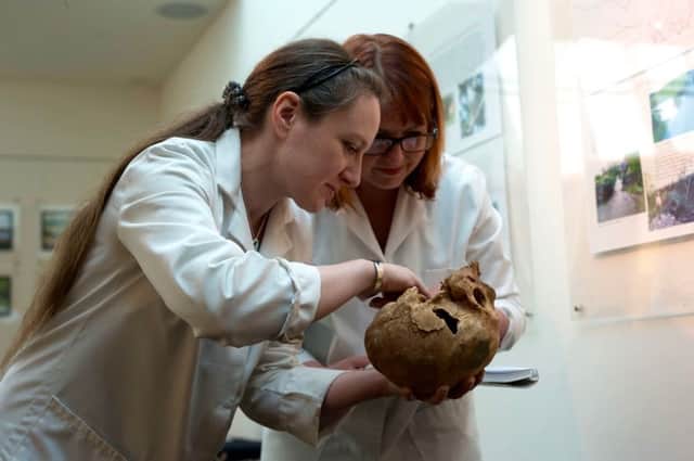 Dr. Anwen Caffell and colleague Rebecca Gowland examining a cranium from Fewston at Durham University.