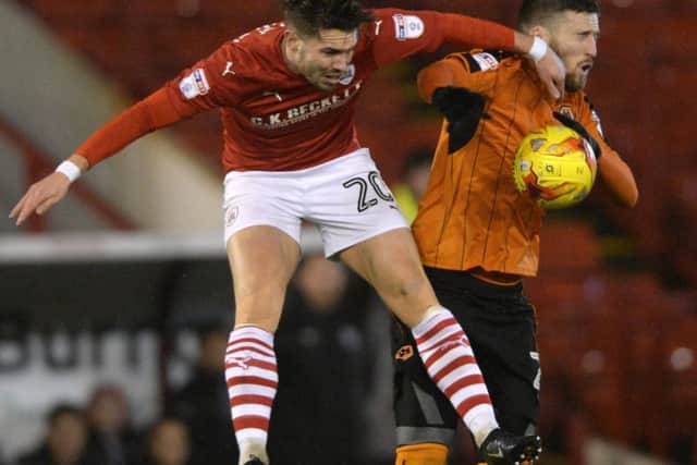 Tom Bradshaw beats Jack Price to a high ball in 
Barnsley's recent game with Wolverhampton Wanderers. (Picture: Bruce Rollinson)