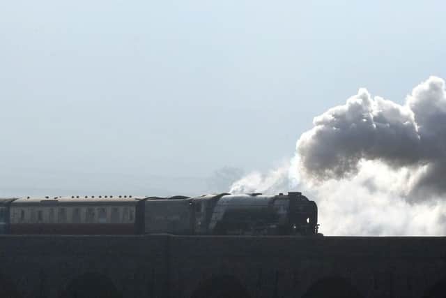 The Tornado locomotive pulls the first timetabled main line steam-hauled service for half a century across the Ribblehead viaduct in North Yorkshire.