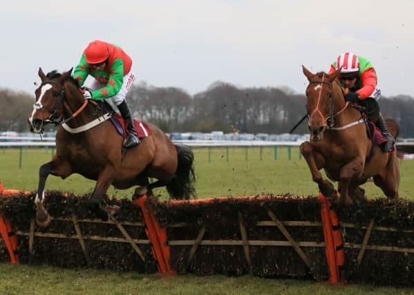 Definitly Red, right, ridden by Richard Johnson, on its way to winning the Albert Bartlett Novices Hurdle Race at Haydock Park (Picture: Nigel French/PA Wire).