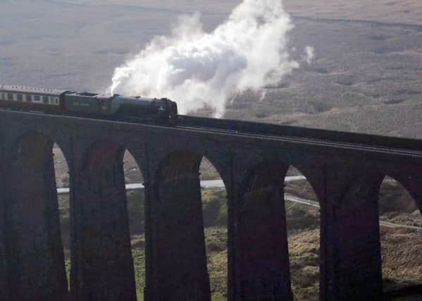 Power line: The Tornado crossing the famous Ribblehead viaduct on the Settle-Carlisle line.  (PICTURE: PA).