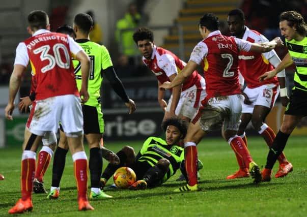 Huddersfield's Izzy Brown is crowded out in the Rotherham box.