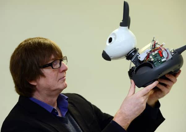 Professor Tony Prescott with MiRo, a pet robot developed in Sheffield. (Scott Merrylees).