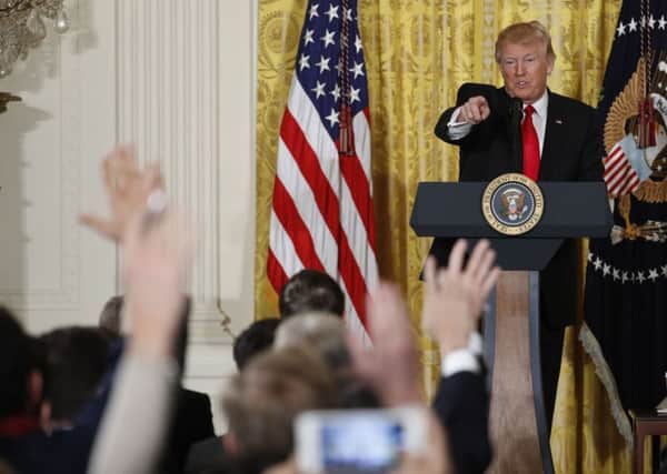 President Donald Trump calls on a reporter during a news conference.