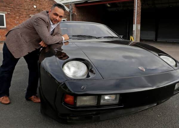 Raj Sedha, of Adel, with the Black Porsche 928 S Coupe that was once owned by Beatle George Harrison. Peter Byrne/PA Wire