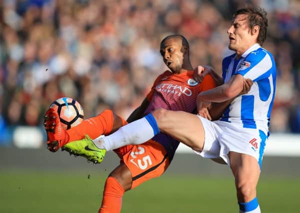 Manchester City's Fernandinho and Huddersfield Town's Dean Whitehead battle for the ball (Picture: Mike Egerton/PA Wire).