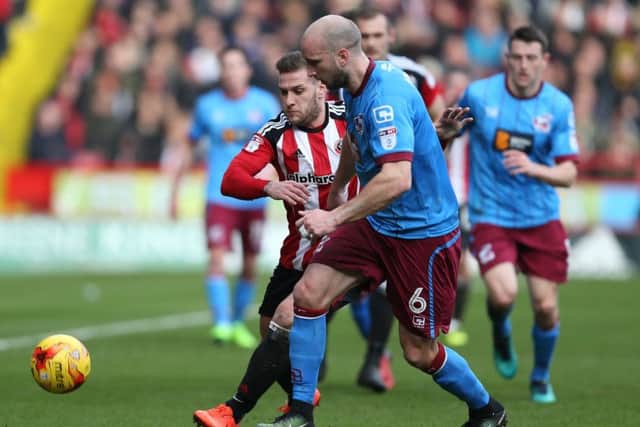 Sheffield United goalscorer Billy Sharp takes on Scunthorpe United's David Mirfin (Picture: Simon Bellis/Sportimage).