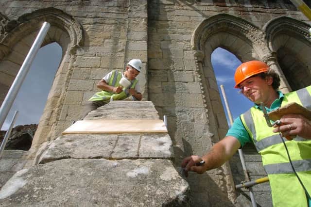 English Heritage help ancient Flying Buttress from Collapse at Rievaulx Abbey. Pictured are masons Simon Dean, 18, from Heckmondwike and Bill Tuley from Sherburn in Elmet, at work on the arch of the buttress.  August 7, 2006.
