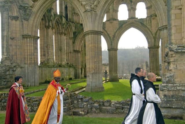 The Archbishop of York Dr John Sentamu  followed in the footsteps of  St Aelred of Rievaulx walking from Helmlsey to Rievaulx  as part of the site's 900th anniversary celebration s, pictured is the Archbishop  processing into Rievaulx Abbey  to hold a celebration service. 2010