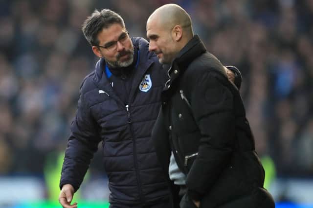 Huddersfield Town manager David Wagner (left) and Manchester City manager Pep Guardiola chat during Saturday's FA Cup tie. Picture: Mike Egerton/PA.