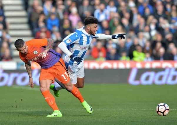 Huddersfield's Philip Billing is tripped by Manchester City's Aleksandar Kolarov. Picture: Bruce Rollinson