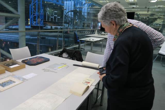 Nan Hudson and research fellow Dr Oli Betts examine George Hudson documents at the York museum
