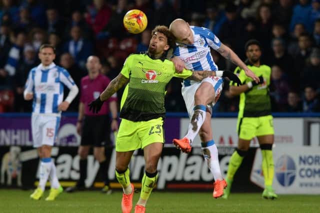 Huddersfield Town's Aaron Mooy beats Reading's Danny Williams to the ball (Picture: Bruce Rollinson).
