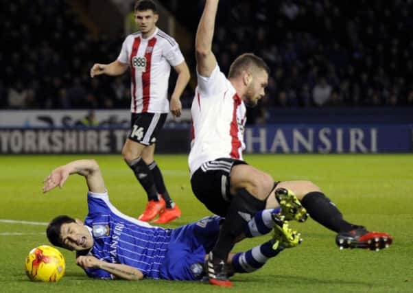 Fernando Forestieri, who scored a late goal for Sheffield Wednesday in their defeat to Brentford, loses out to Harlee Dean (Picture: Steve Ellis).