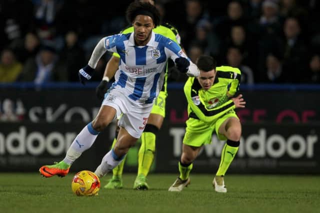 Huddersfield Town's Isaiah Brown turns and sprints away from Reading's Liam Kelly. Picture: PA.