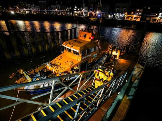 Whitby RNLI volunteer crew launch the all-weather lifeboat to respond to a yacht in difficulties. Credit: Ceri Oakes/RNLI