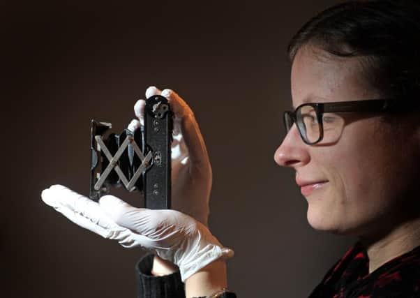 Heather Jakubiak with a Kodak vest pocket camera from WWI  at the National Media Museum in Bradford. Picture: Tony Johnson
