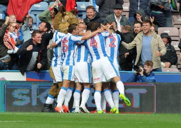 Jonathan Hogg is mobbed by team-mates after scoring Huddersfield Towns late winner against Barnsley back in August (Picture: Jonathan Gawthorpe).