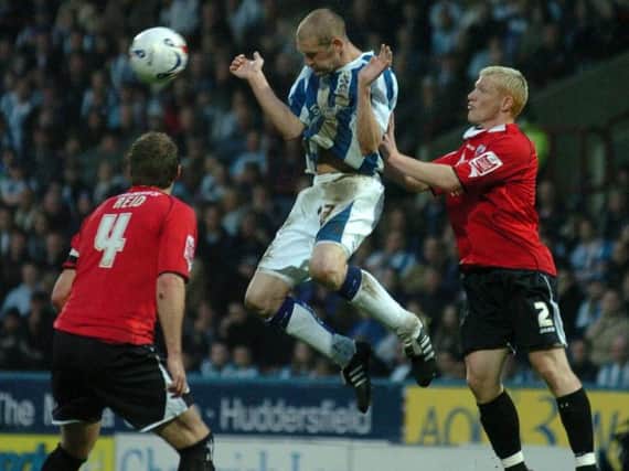 Huddersfield Town's Andy Booth rises to win a header against Barnsley in 2006