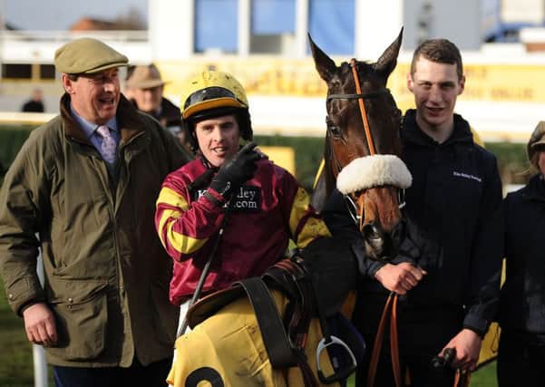 Jockey Jason Maguire (second left) poses with winning connections and trainer Kim Bailey (left) after winning the Betfair Denman Chase with Harry Topper at Newbury. Picture: Andrew Matthews/PA