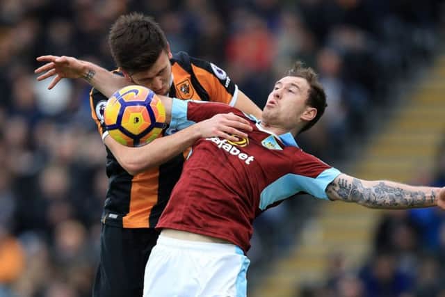 Hull City's Harry Maguire (left) and Burnley's Ashley Barnes battle for the ball (Photo: PA)