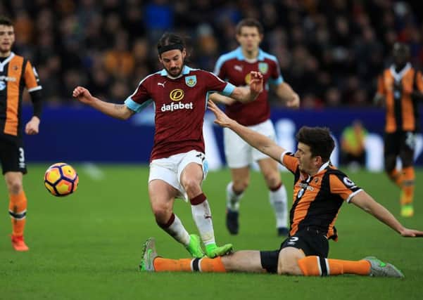 Burnley's George Boyd (centre) and Hull City's Harry Maguire battle for the ball.