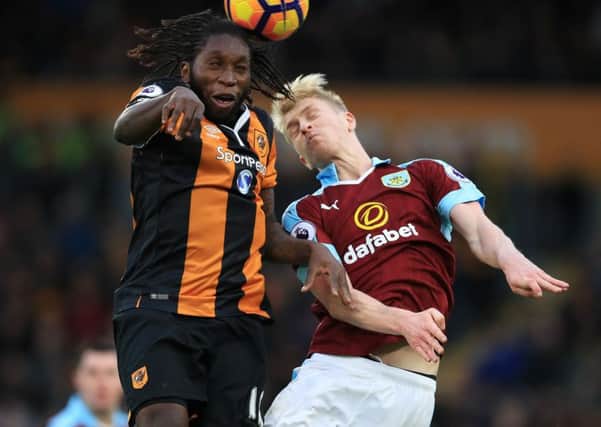 Hull City's Dieumerci Mbokani, left, and Burnley's Ben Mee battle for the ball (Picture: Mike Egerton/PA Wire).
