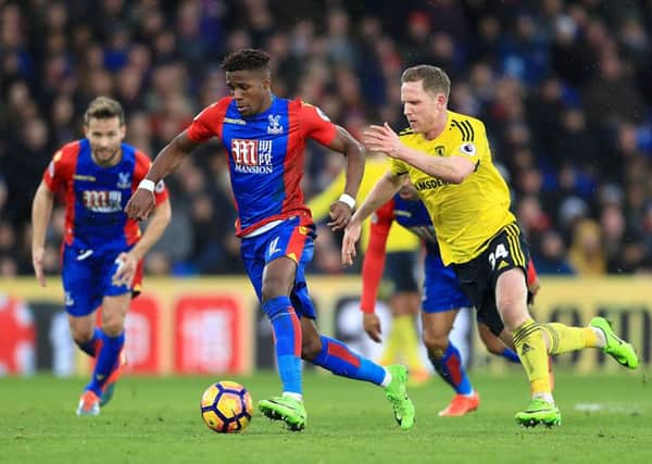 Crystal Palace striker Wilfried Zaha is challenged by Middlesbroughs Adam Forshaw at Selhurst Park (Picture: PA).