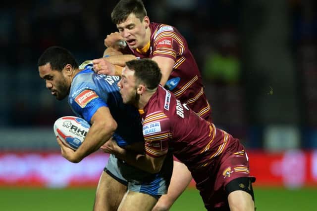 Bill Tupou is held by Ryan Brierley and Sam Wood.   Picture Bruce Rollinson