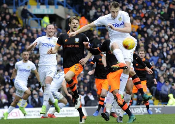 Leeds United match-winner Chris Wood clears from Sheffield Wednesdays Glenn Loovens (Picture: Steve Ellis).