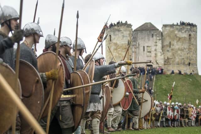 Viking re-enactors take part in a mock battle during the JORVIK Viking Festival in York.