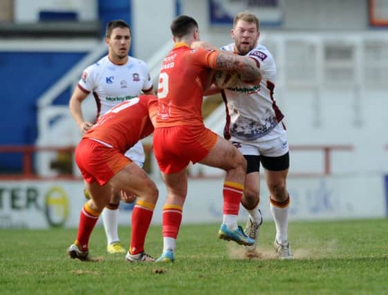 Batley's Brad Day is tackled by Sheffield's Matty Fozard.  Picture: Jonathan Gawthorpe