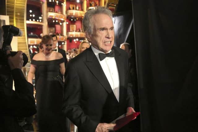 Warren Beatty exits the stage after announcing the award for best picture at the Oscars.