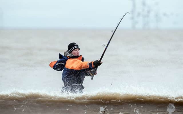 An angler competes in the world's largest beach angling festival on Tunstall Beach in Yorkshire.
