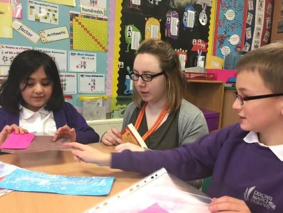 Teacher training student Frankie Clayton talks to pupils at Dixons Marchbank Primary School, in Bradford, during a recent bus tour.