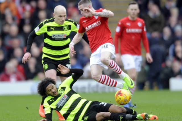 Barnsley player Ryan Kent is challenged by Izzy Brown. Picture: Simon Hulme
