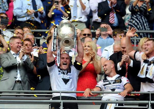 Hull's captain Gareth Ellis lifts the Challenge Cup trophy last year.