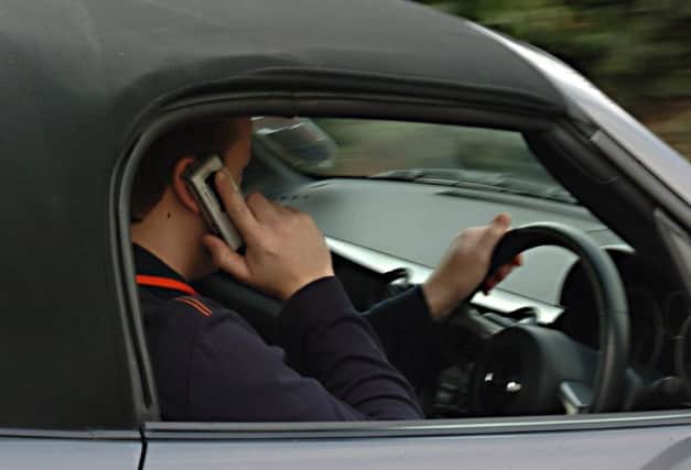 Tougher penalties for motorists who use their mobile phones while behind the wheel don't go far enough according to one letter writer. Do you agree? Pictured posed by model.