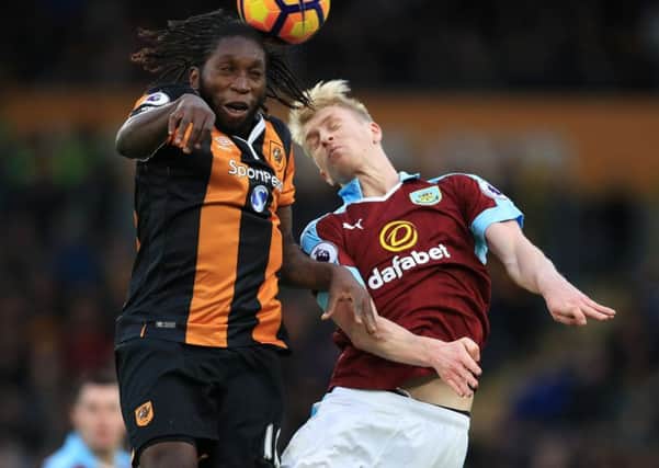 Hull City's Dieumerci Mbokani challenges Burnley's Ben Mee during Saturday's game (Picture: Mike Egerton/PA Wire).