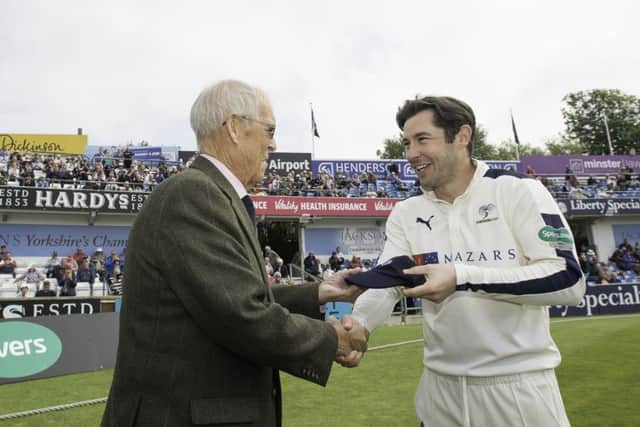 Yorkshire's Andrew Hodd is presented with his county cap last May by club president John Hampshire. Picture: SWPix