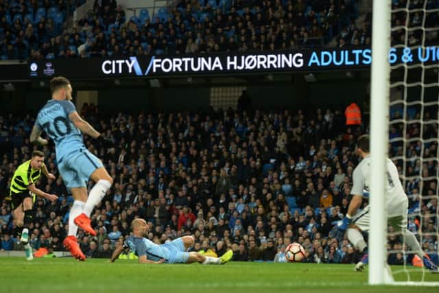 GET IN: Harry Bunn scores Huddersfield's early goal against Manchester City at the Etihad Stadium.  Picture: Bruce Rollinson