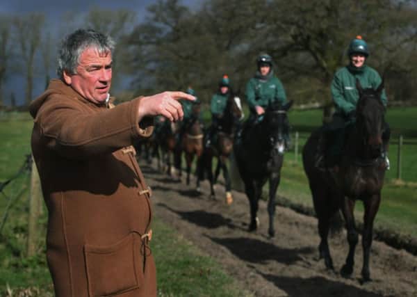Pointing the way: Trainer Nigel Twiston-Davies overlooks his horses on the gallops. (Picture: PA)