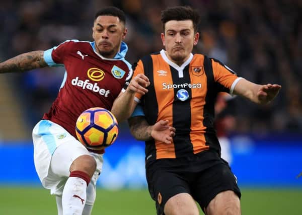 Hull City's Harry Maguire challenges Burnley's Andre Gray for the ball (Picture: PA)